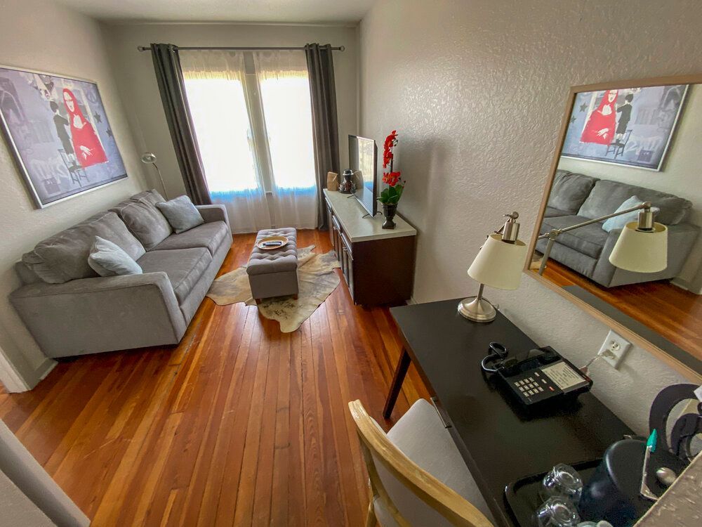 A living room with a couch , desk and television