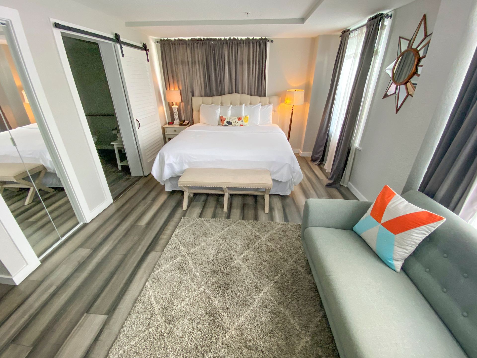 A bedroom with a couch and a large bed