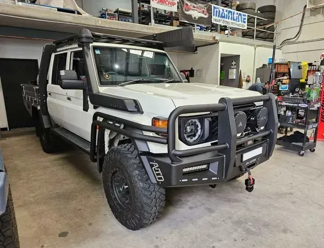 White Off-road Truck With Black Brush Guard, Snorkel, and Large Tires — Greens Diesel Tune in Smeaton Grange, NSW