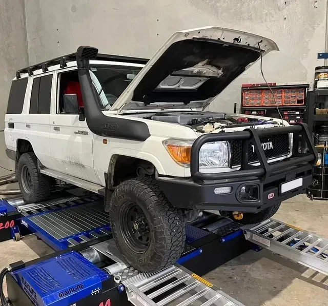 White Toyota Land Cruiser on a Dyno, Hood Open — Greens Diesel Tune in Smeaton Grange, NSW