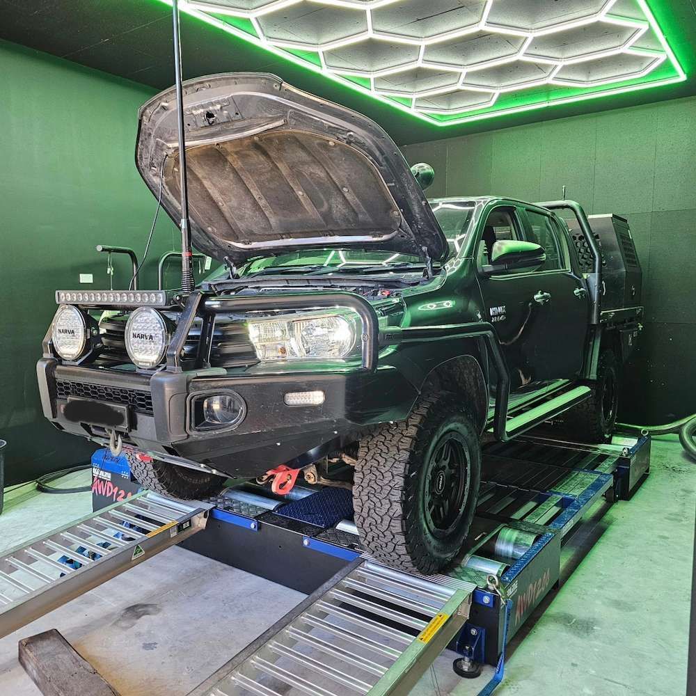 Black Off-road Truck on a Dynamometer, Hood Open — Greens Diesel Tune in Smeaton Grange, NSW