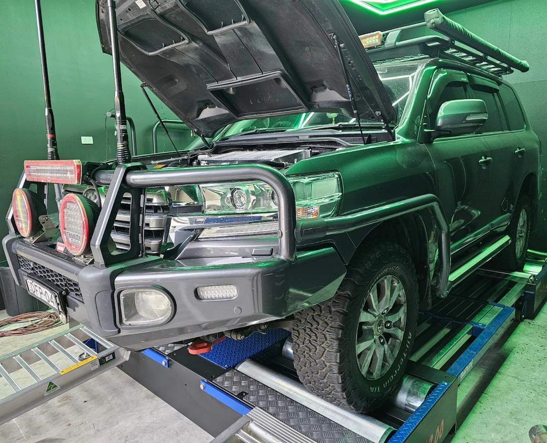 Green Suv With Open Hood on a Dynamometer, in a Workshop — Greens Diesel Tune in Narellan, NSW