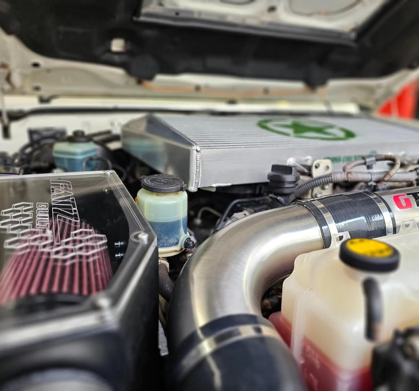 Close-up of a Car Engine Bay With Custom Air Intake and Filters — Greens Diesel Tune in Smeaton Grange, NSW
