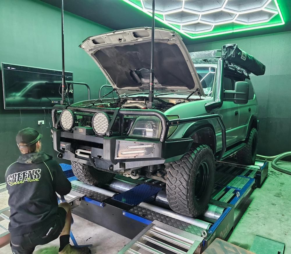A Mechanic Works on a Green Suv on a Dyno Machine — Greens Diesel Tune in Smeaton Grange, NSW