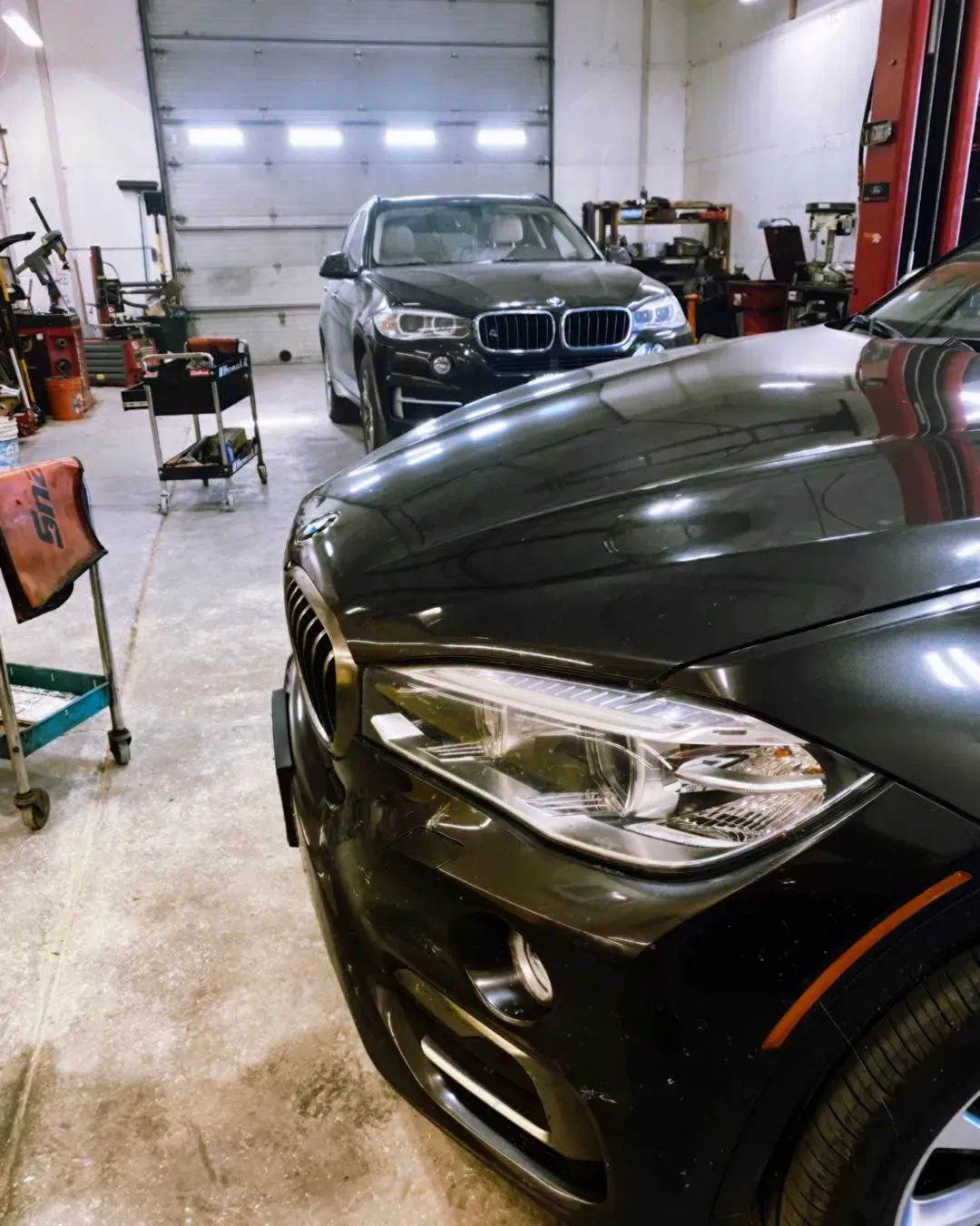 Two black BMW SUVs inside a garage | Karraker Mechanical Solutions