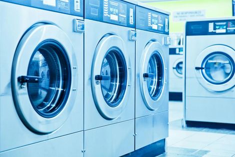A row of washing machines in a laundromat.