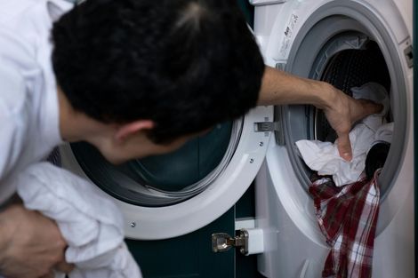 A row of washing machines in a laundromat.