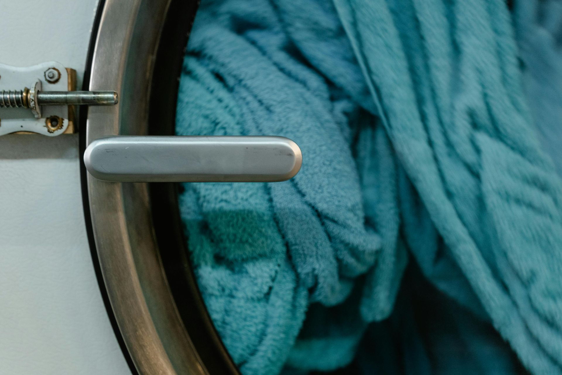 A close up of a washing machine filled with towels.