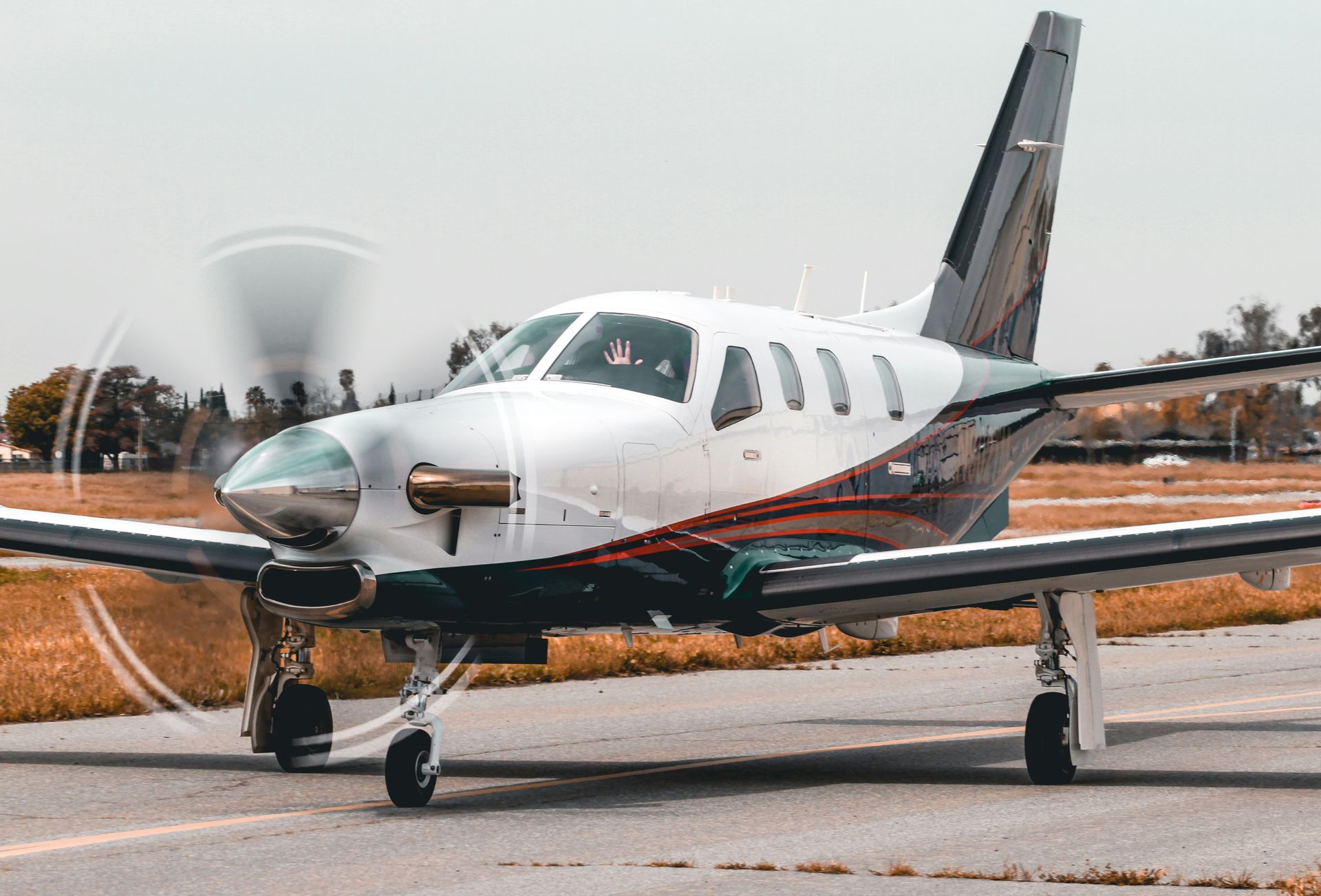 A small propeller plane is parked on a runway.