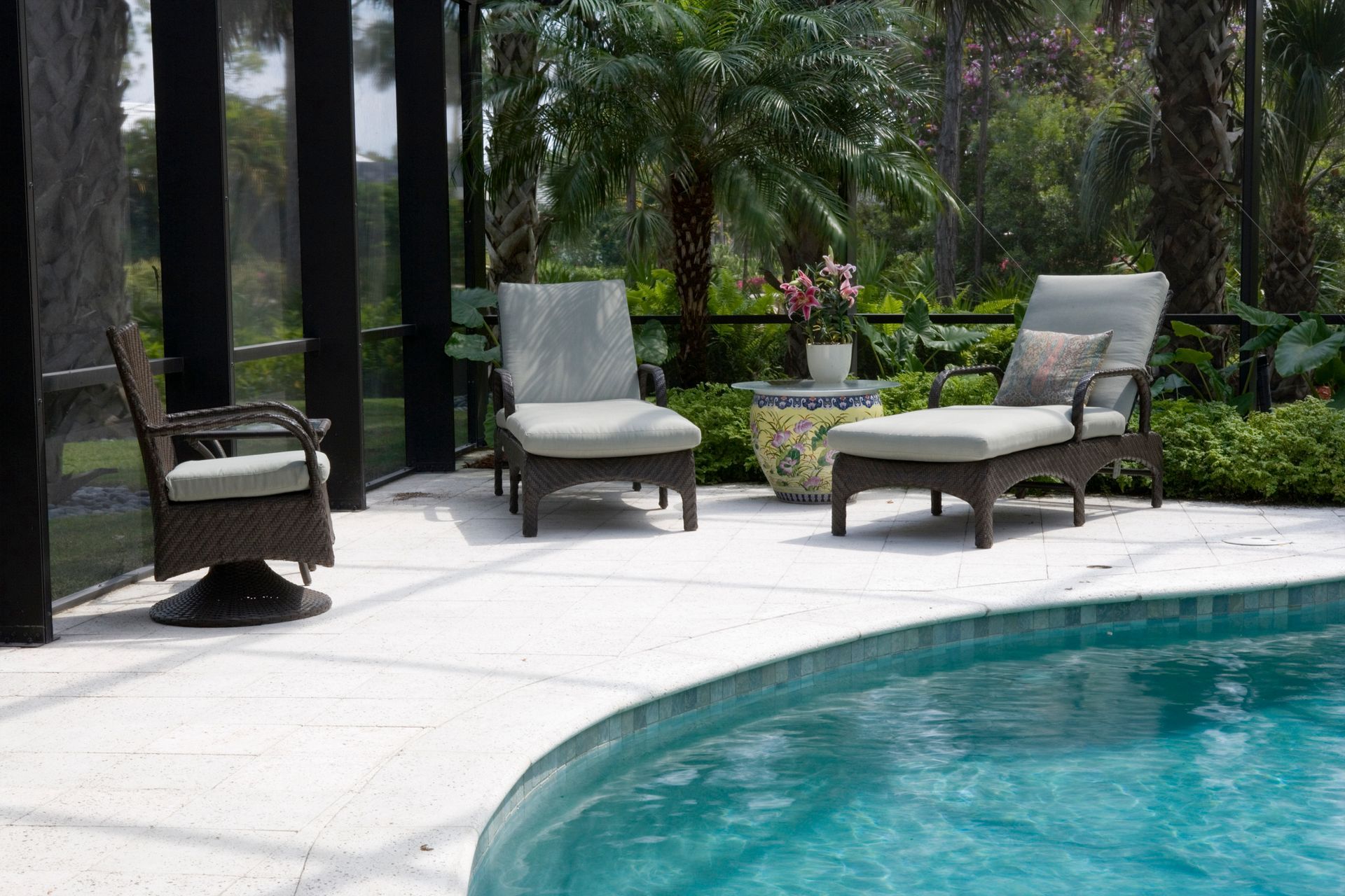 A Patio with Chairs and A Table Next to A Swimming Pool - Mingo, IA - Karns Concrete LLC