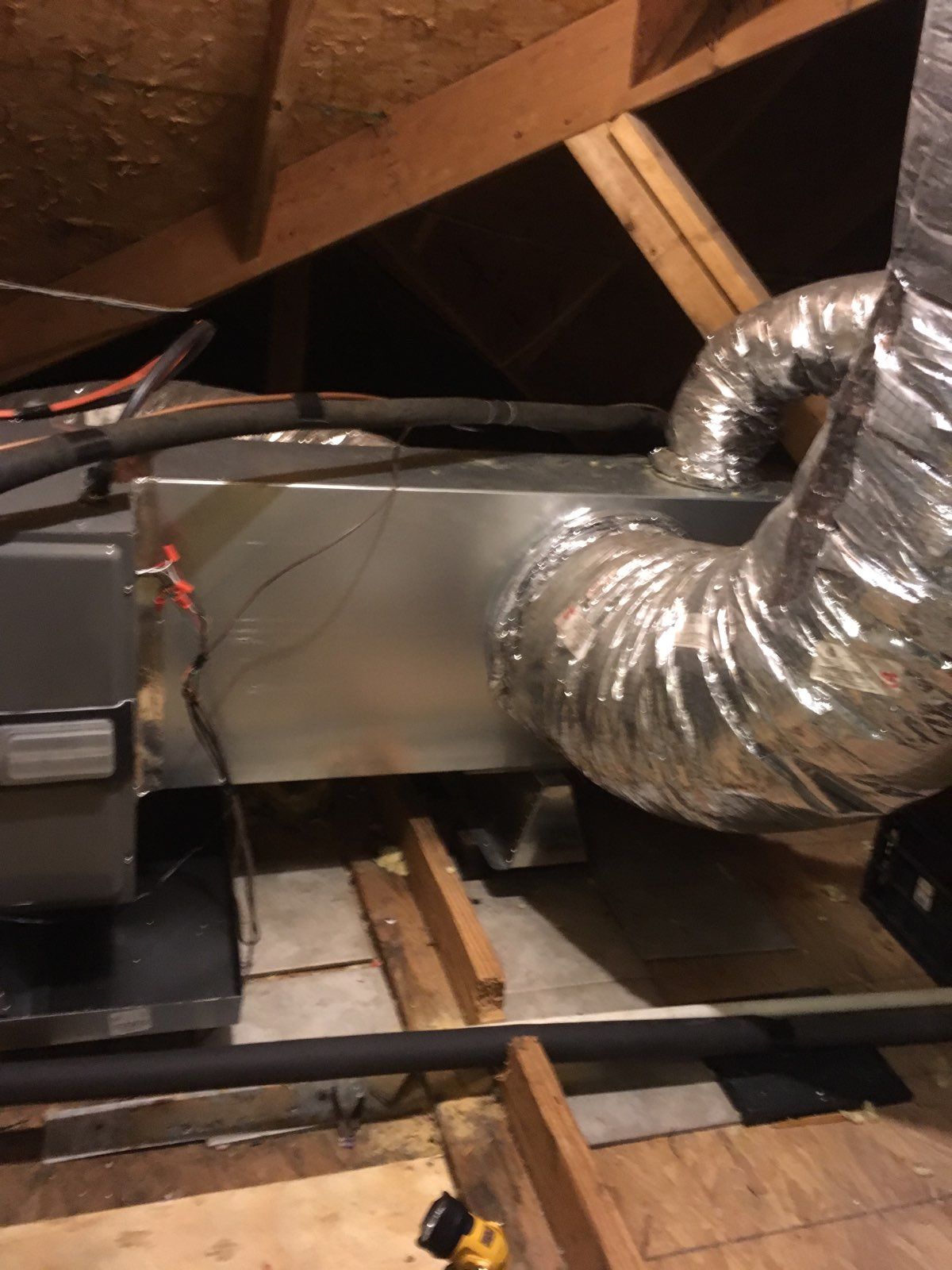 A ventilation system is installed in the attic of a house.