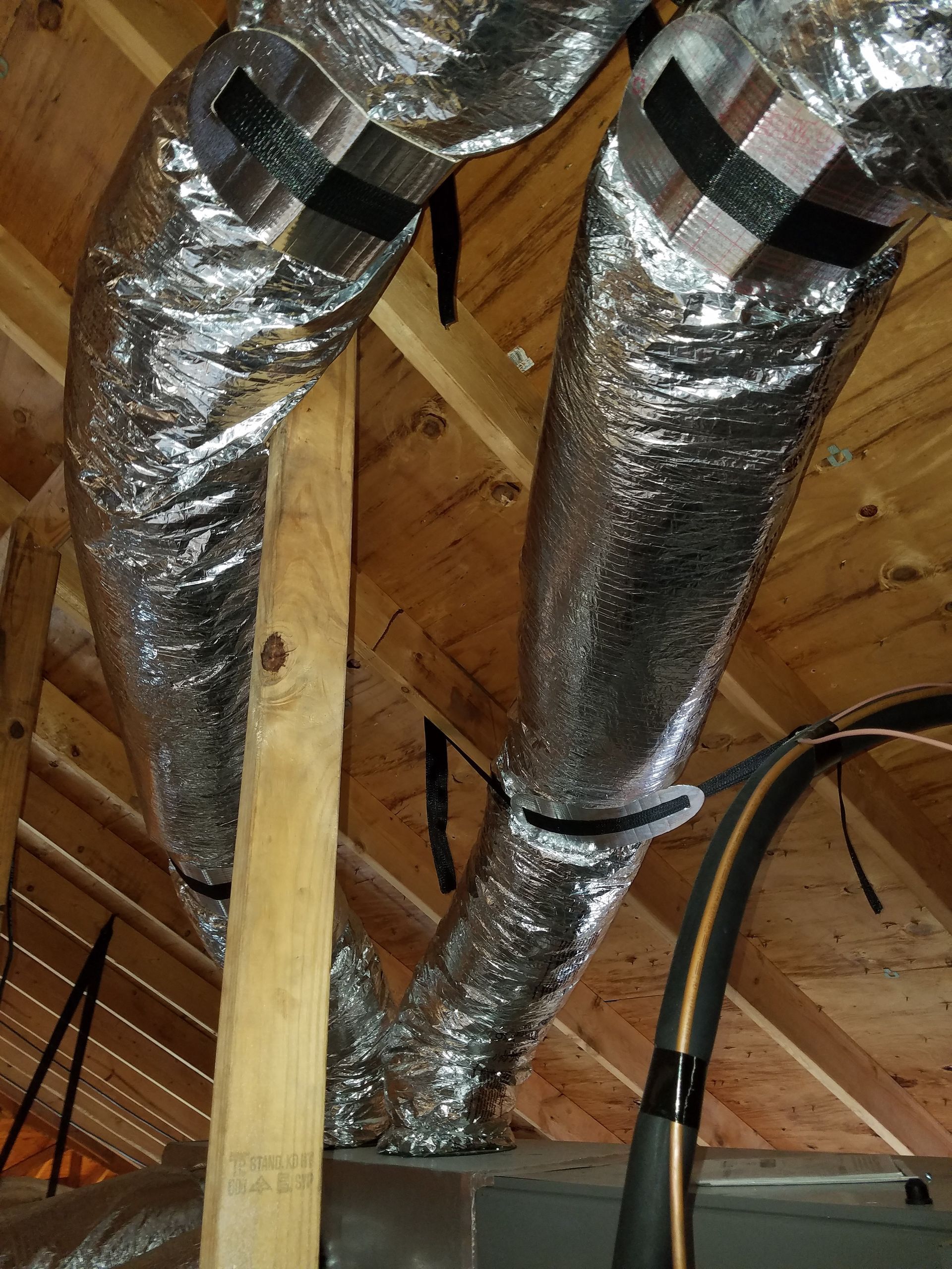 A bunch of ducts hanging from the ceiling of a house