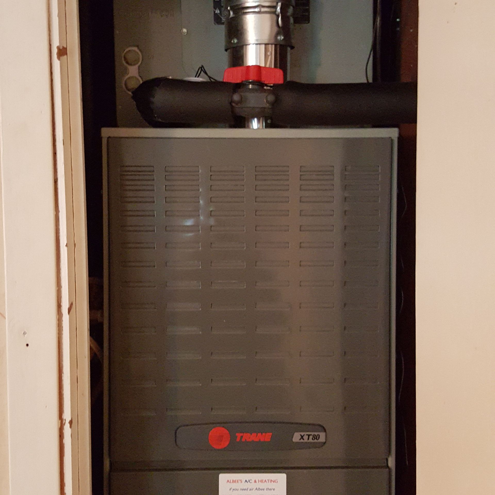 A trane heater is sitting inside of a doorway.