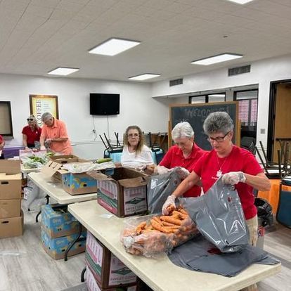 A group of people are preparing food in a room.