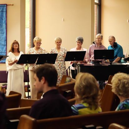 A group of people are singing in a church