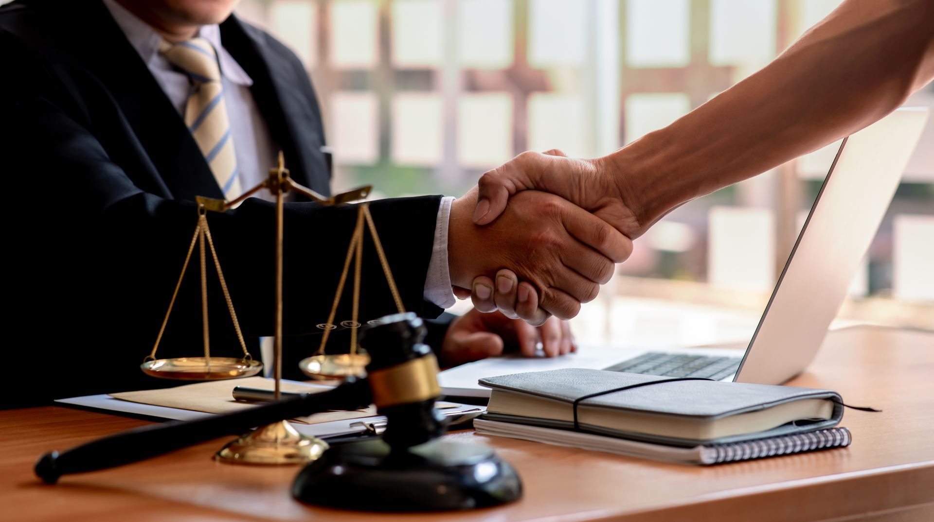 A man is shaking the hand of an attorney.