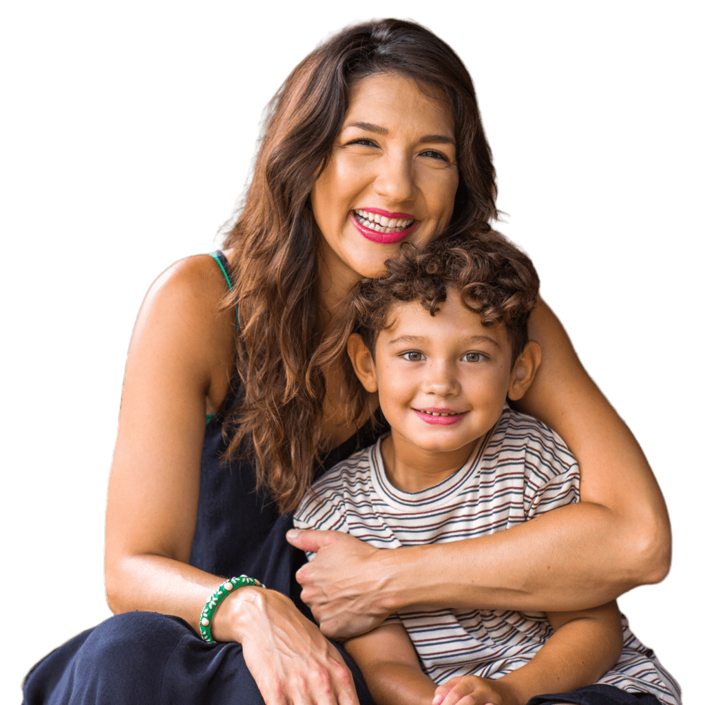 a woman is holding a little boy in her arms .