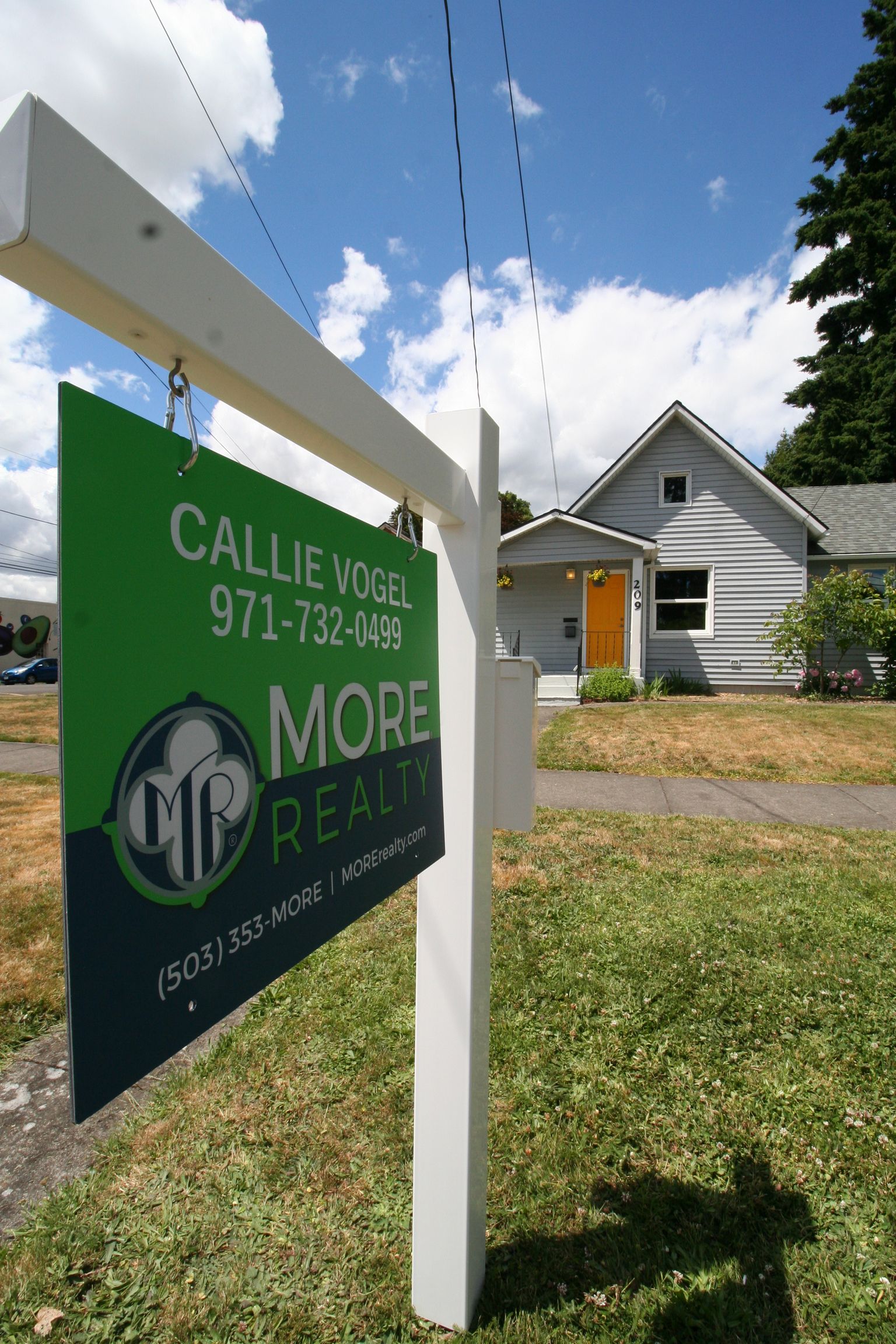 A For Sale sign infront of a home