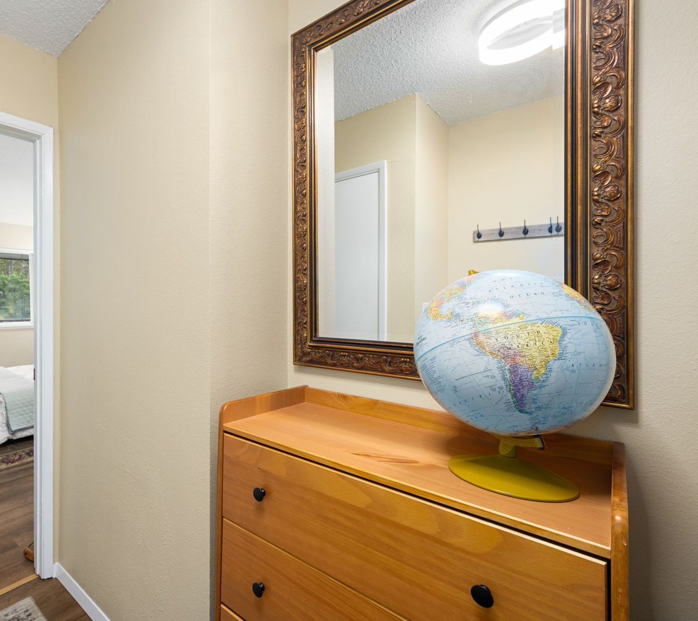 An entry with table, mirror and globe