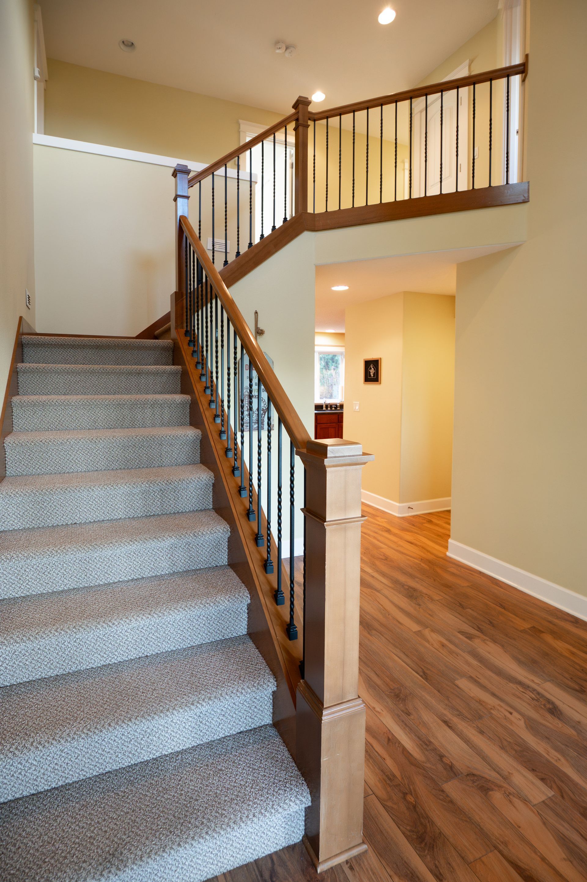 An entry hall with wooden staircase.