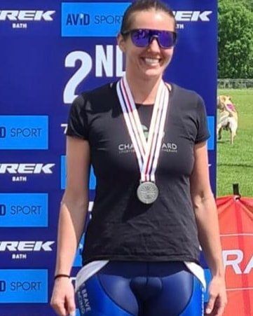 Apache Brave Racing female rider collecting her winning medal after a road race event