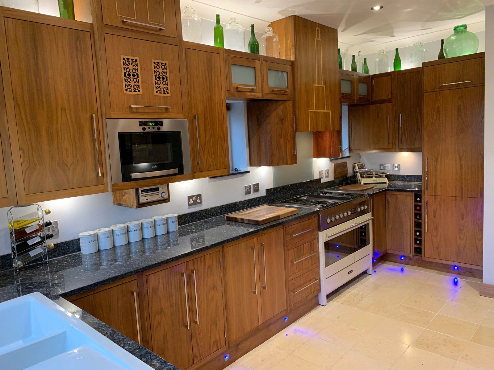 A kitchen with wooden cabinets and black counter tops