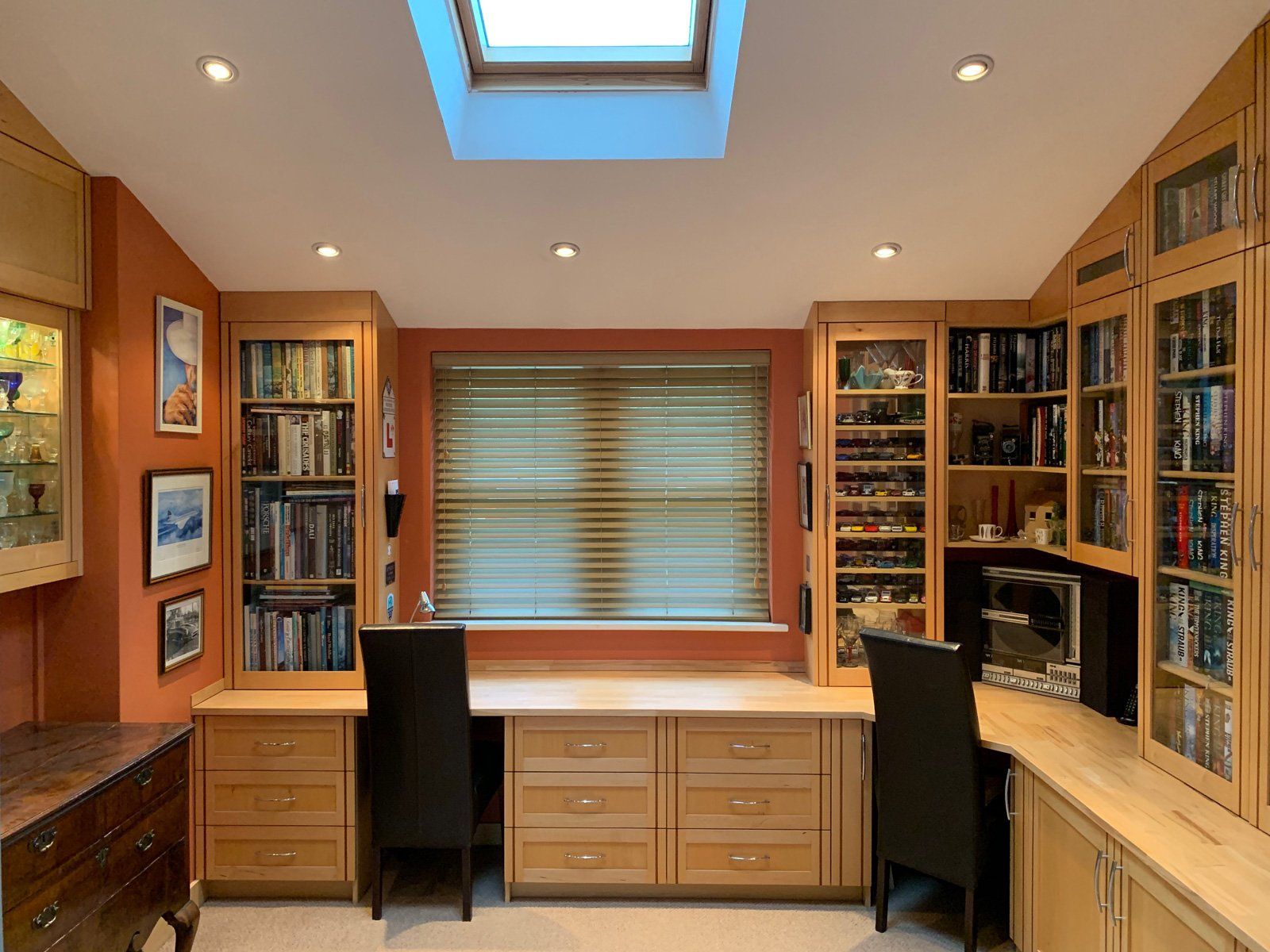 A room with two desks and a skylight in the ceiling
