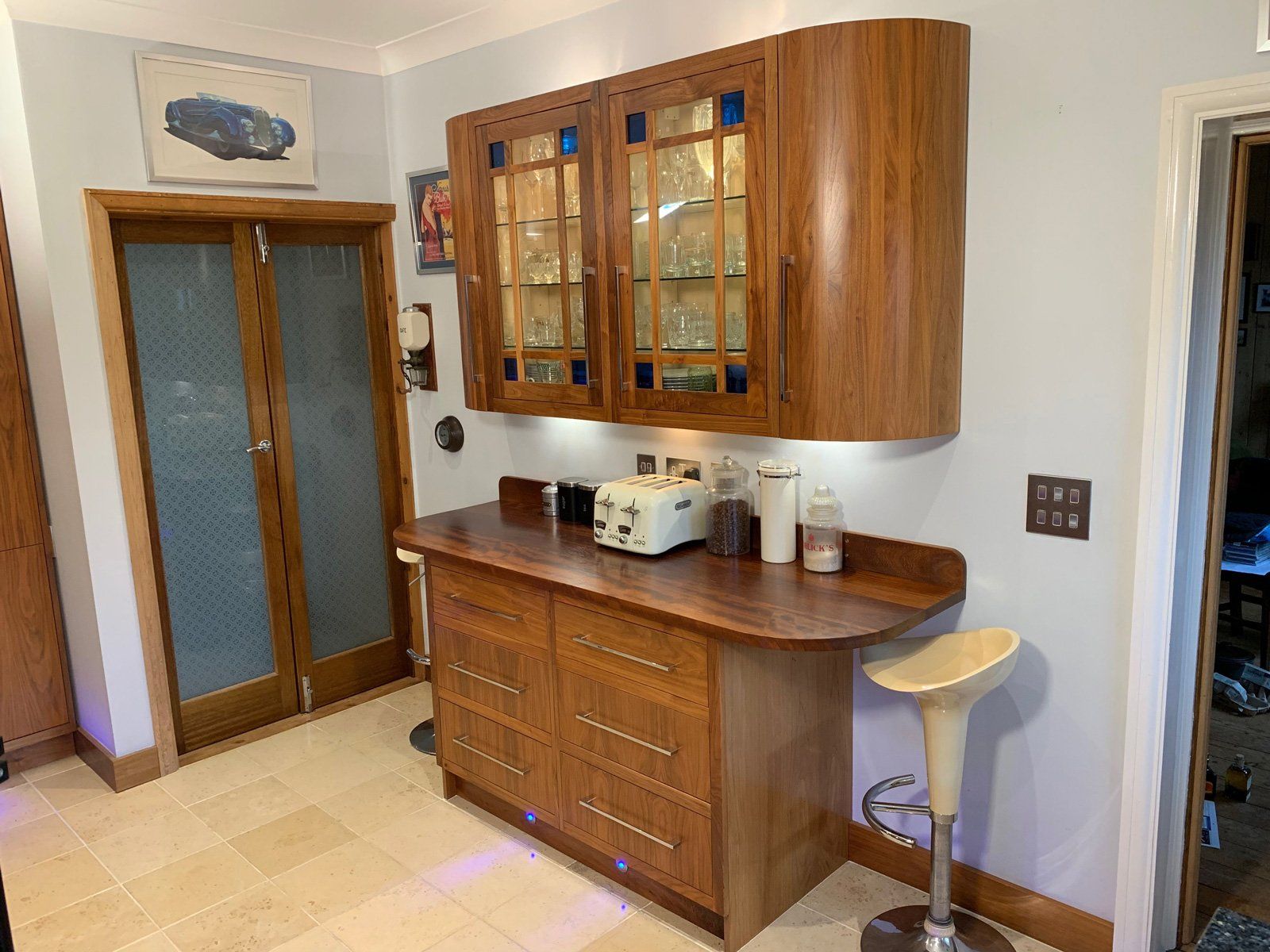 A kitchen with wooden cabinets and a toaster oven on the counter.