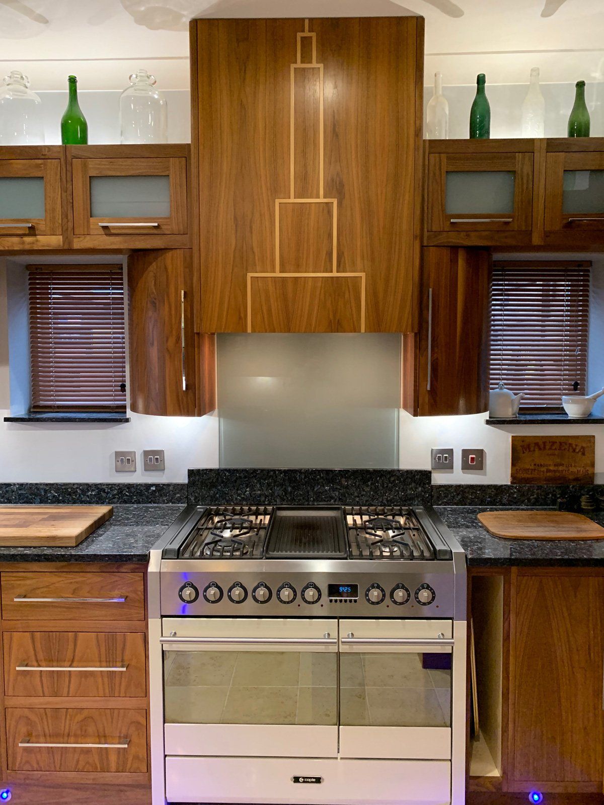 A kitchen with a stove top oven and wooden cabinets