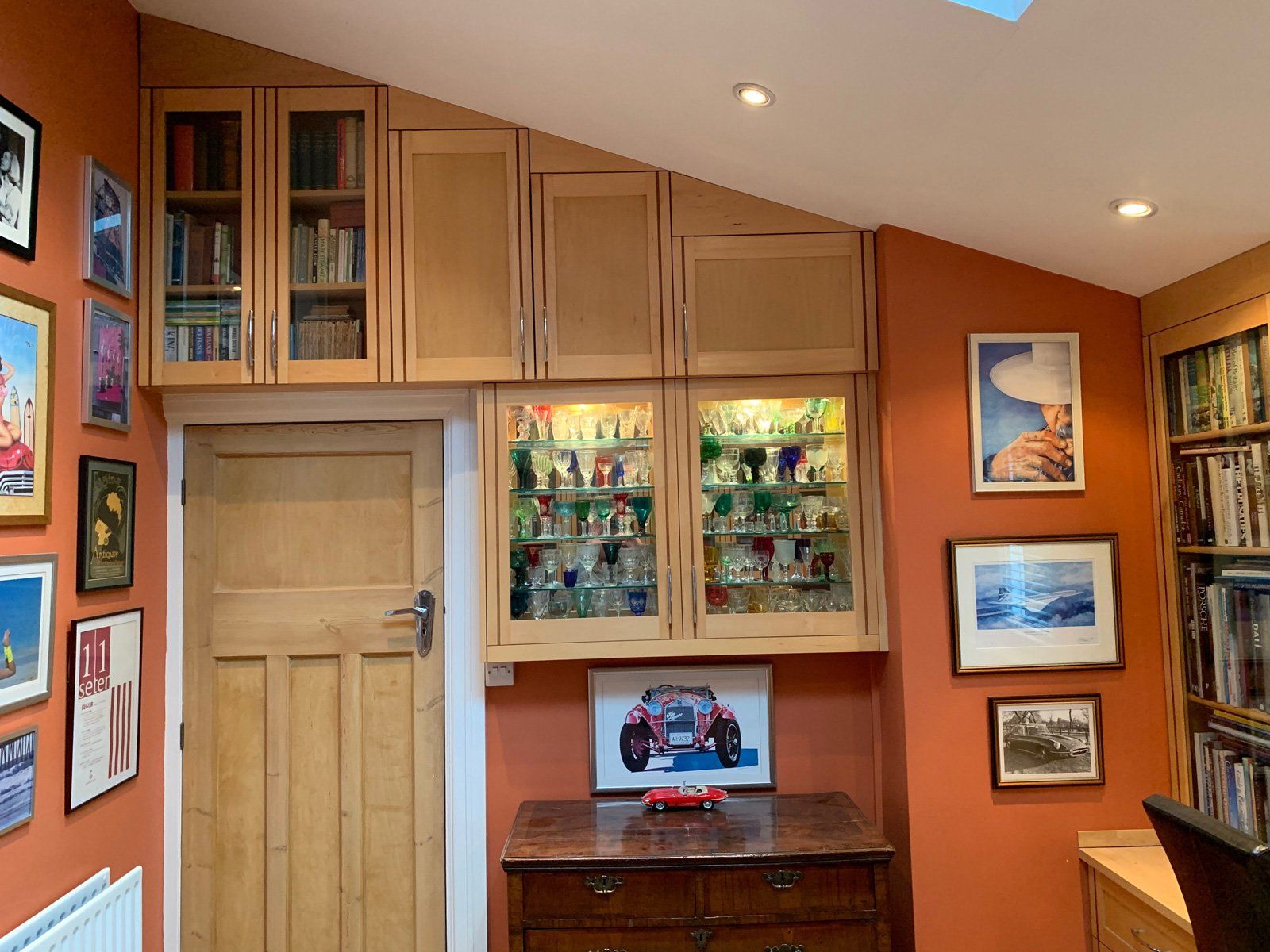 A room with a dresser and a picture on the wall.