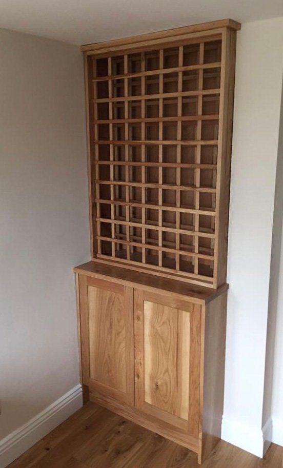 A wooden cabinet with lots of shelves in a room.