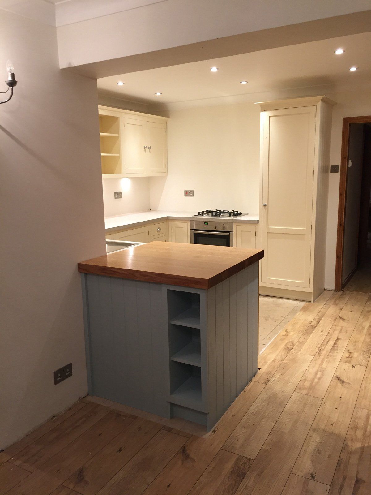 An empty kitchen with a large island in the middle
