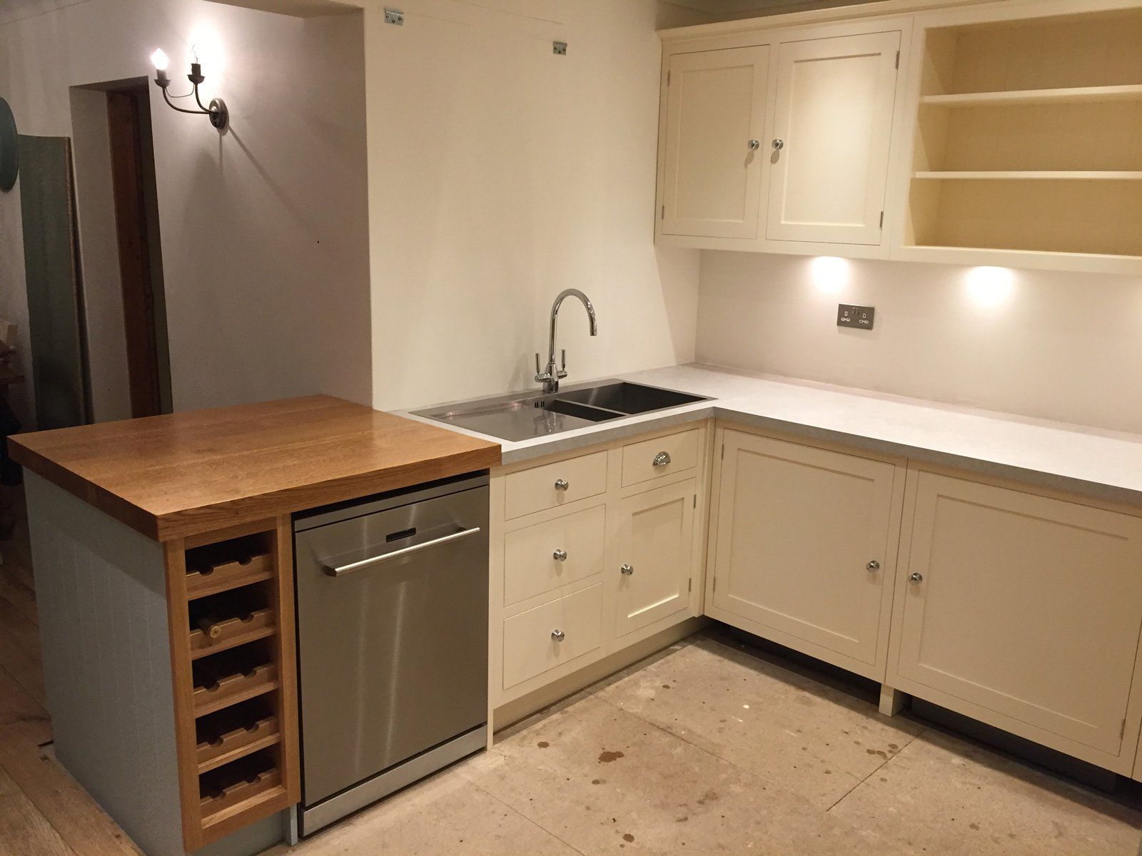 A kitchen with white cabinets and a stainless steel dishwasher