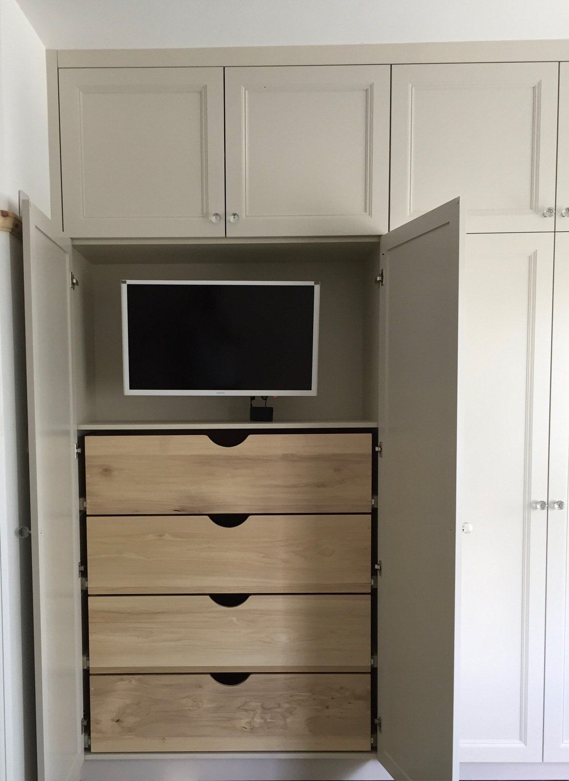 A dresser with drawers and a television in it