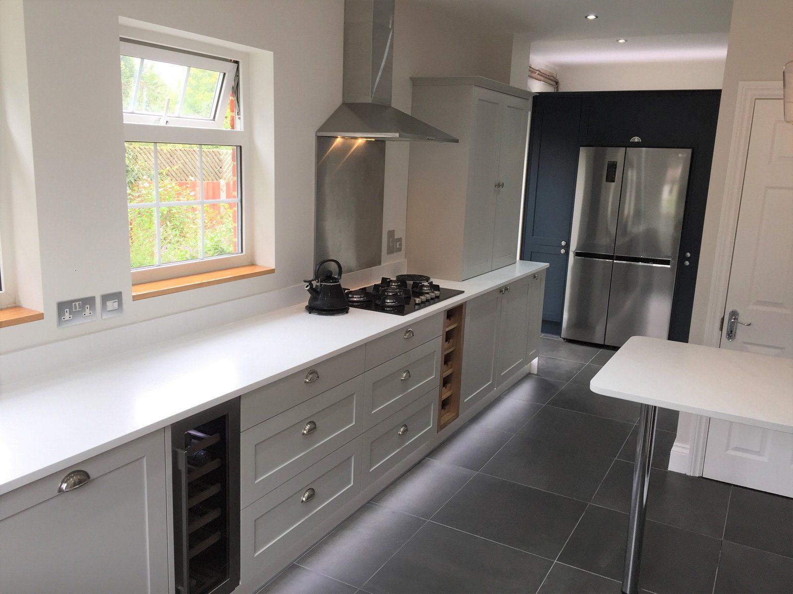 A kitchen with white cabinets and stainless steel appliances