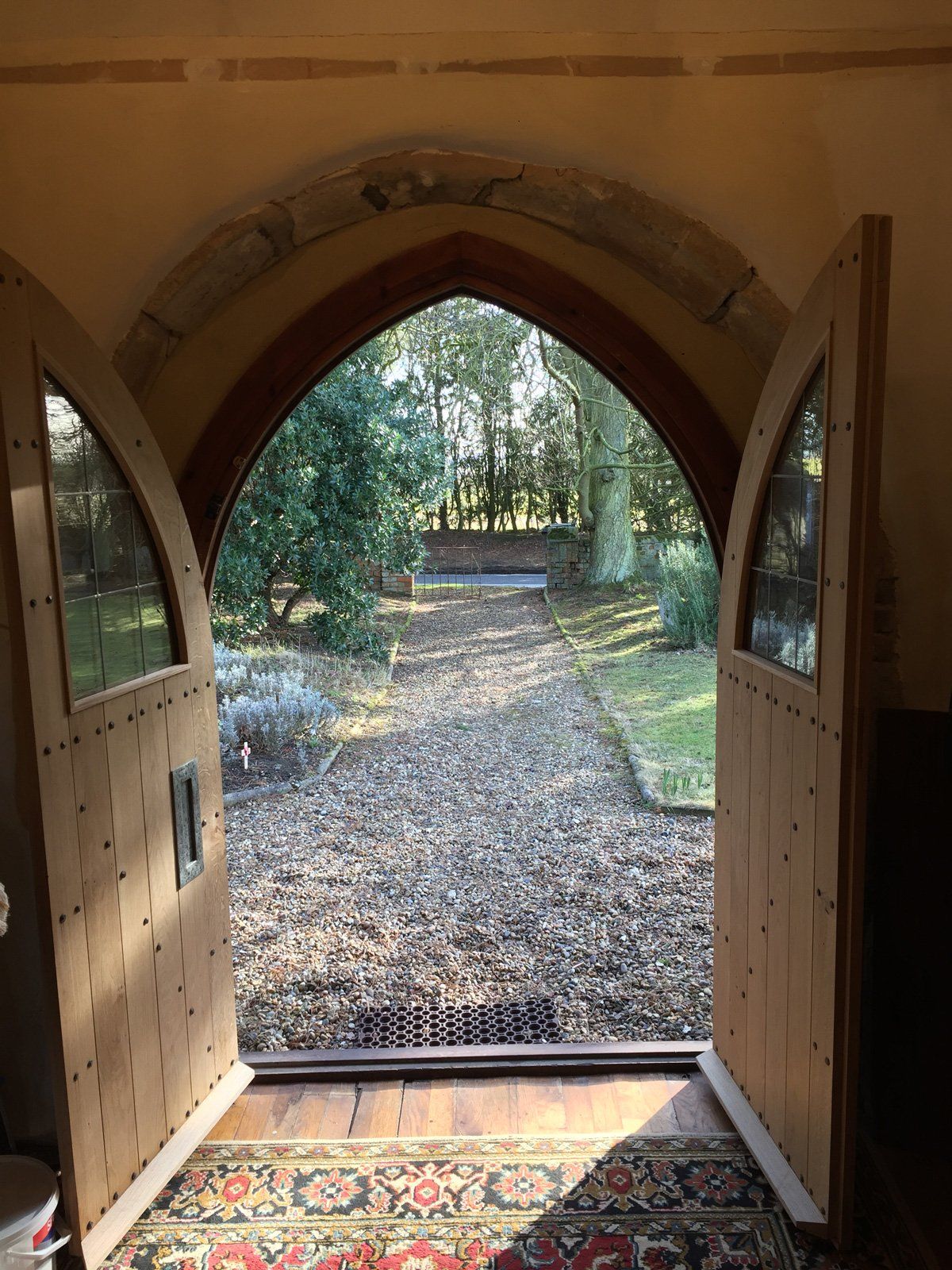 A view of a path through a wooden archway.