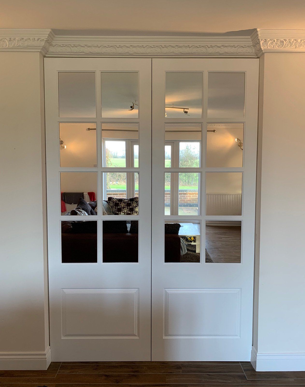 A pair of white sliding glass doors in a living room