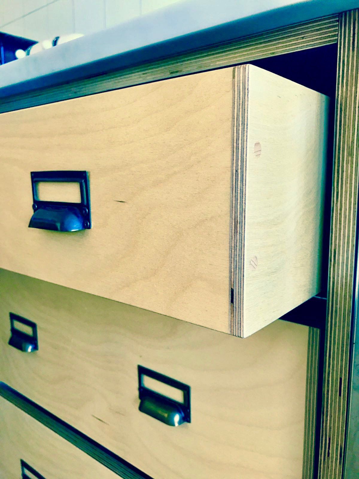 A close up of a wooden drawer with a label on it