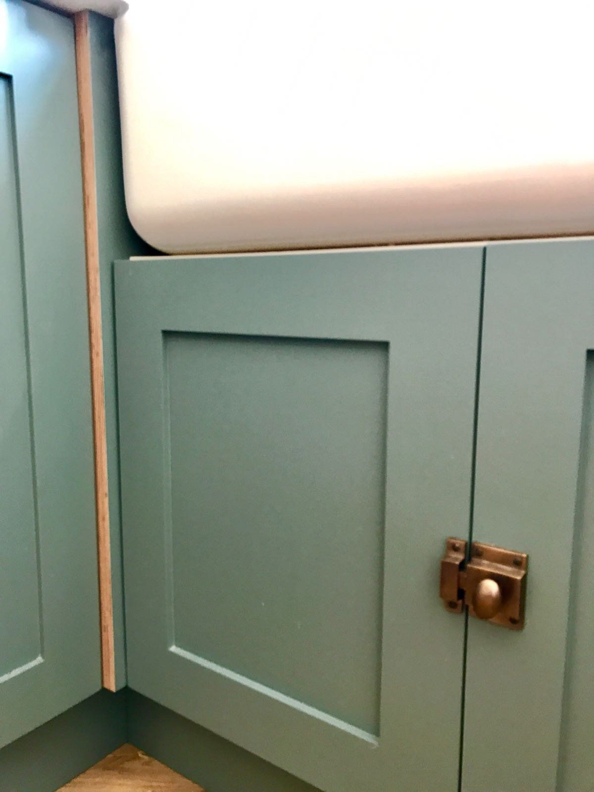 A sink is sitting under a cabinet in a kitchen.