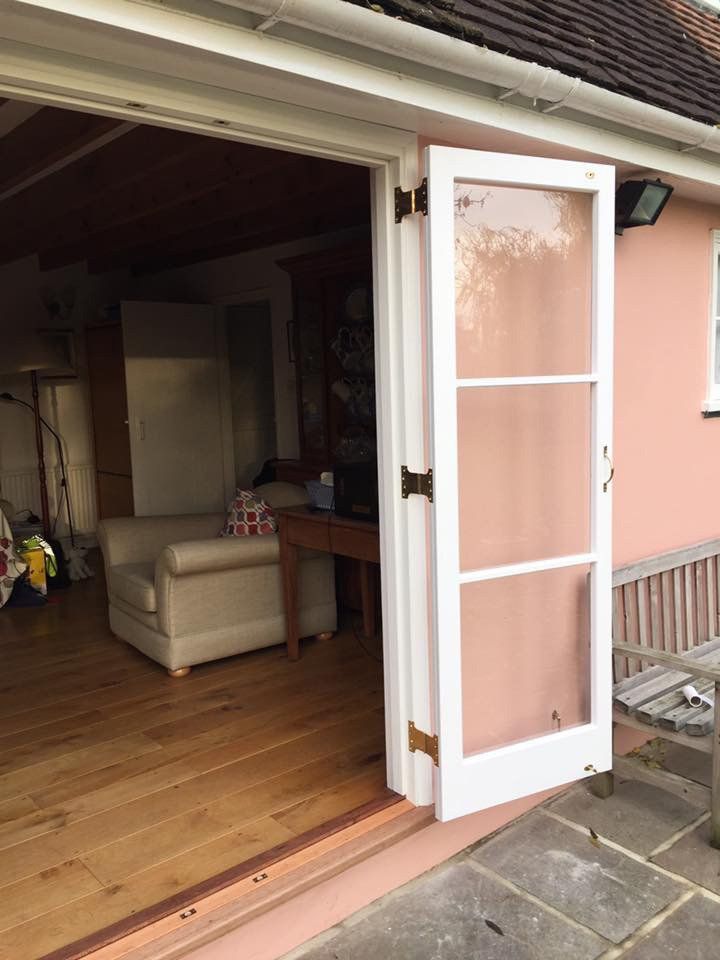 A living room with a sliding glass door open to a patio.