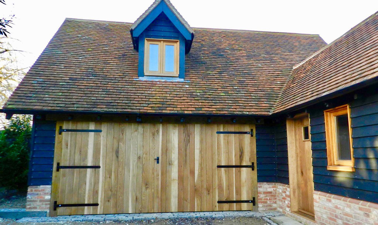 A wooden garage door is sitting in front of a house.