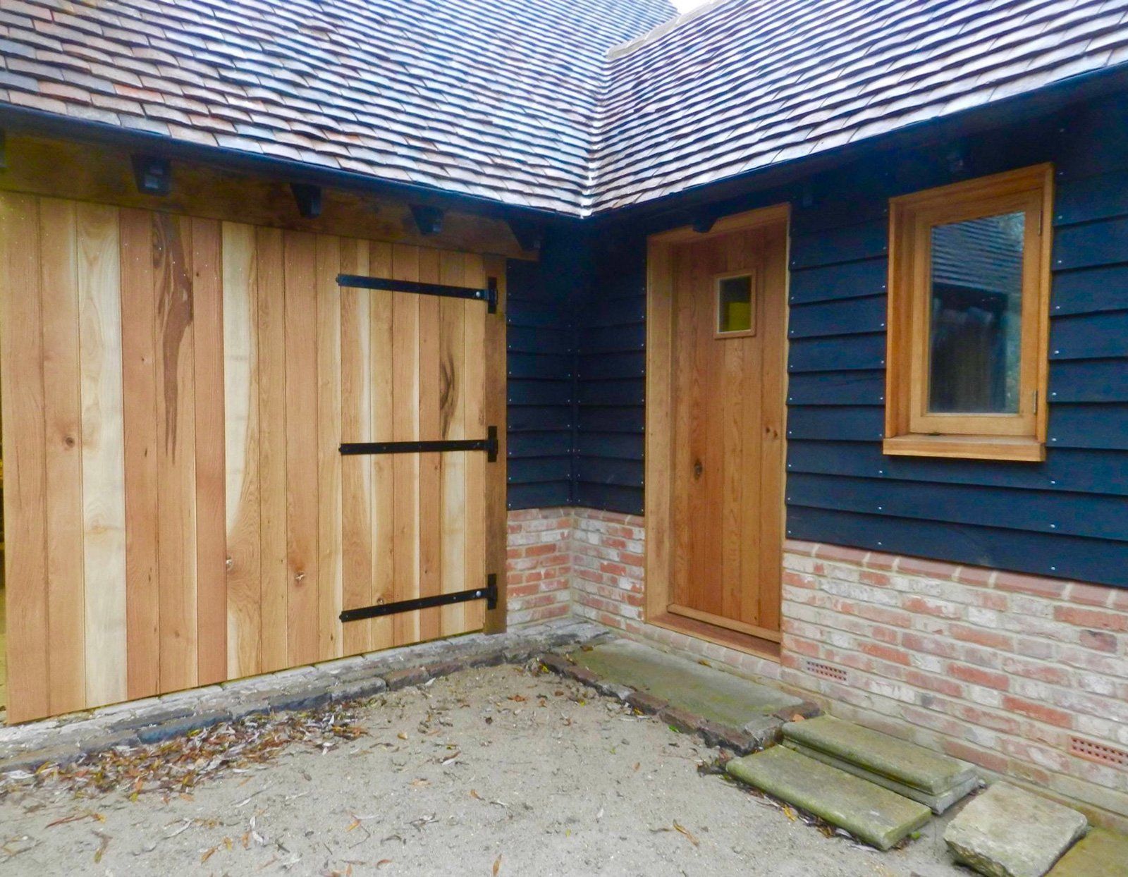 A blue house with a wooden door and window