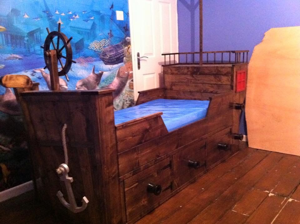 A wooden bed in the shape of a pirate ship