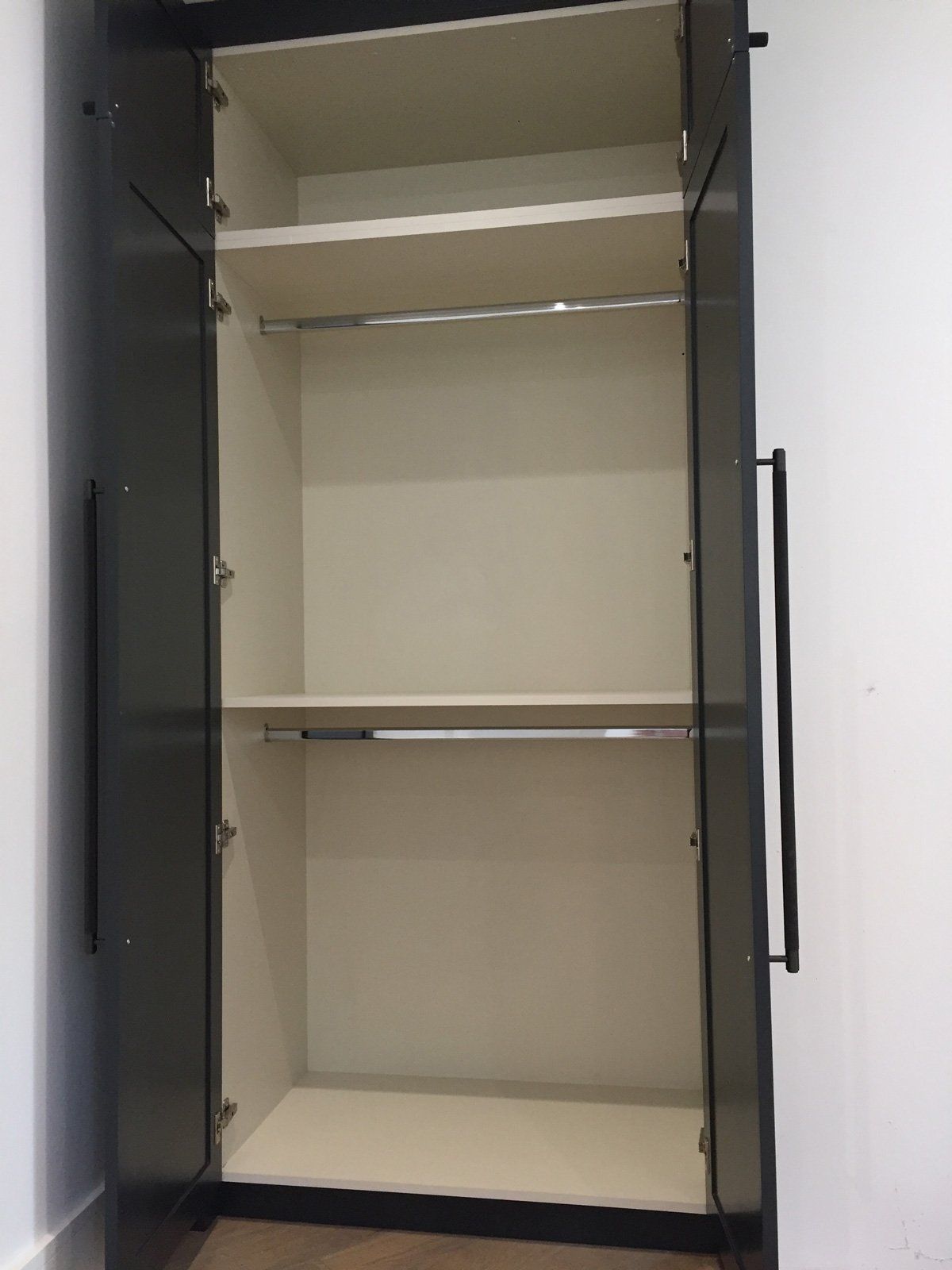 The inside of an empty closet with the doors open