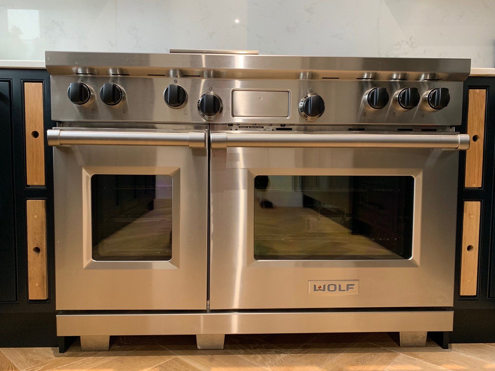 A stainless steel wolf stove in a kitchen