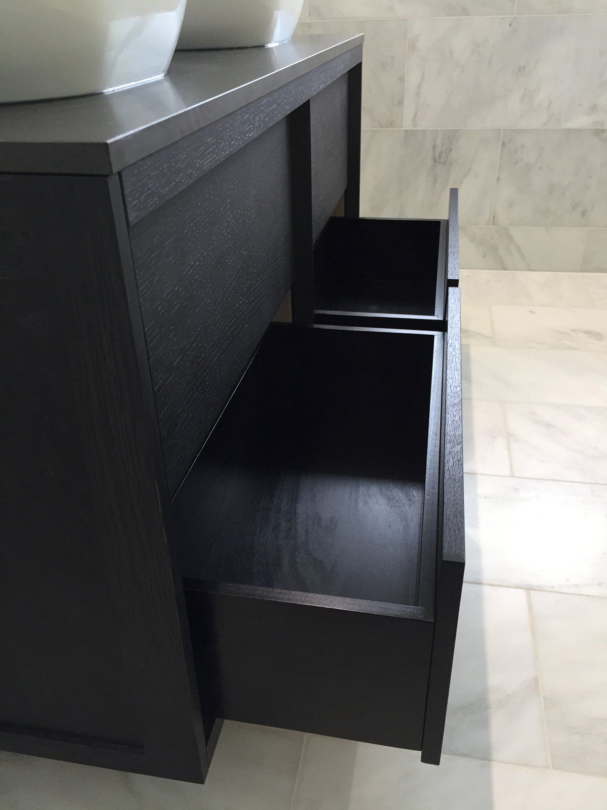 A bathroom vanity with two sinks and two drawers open