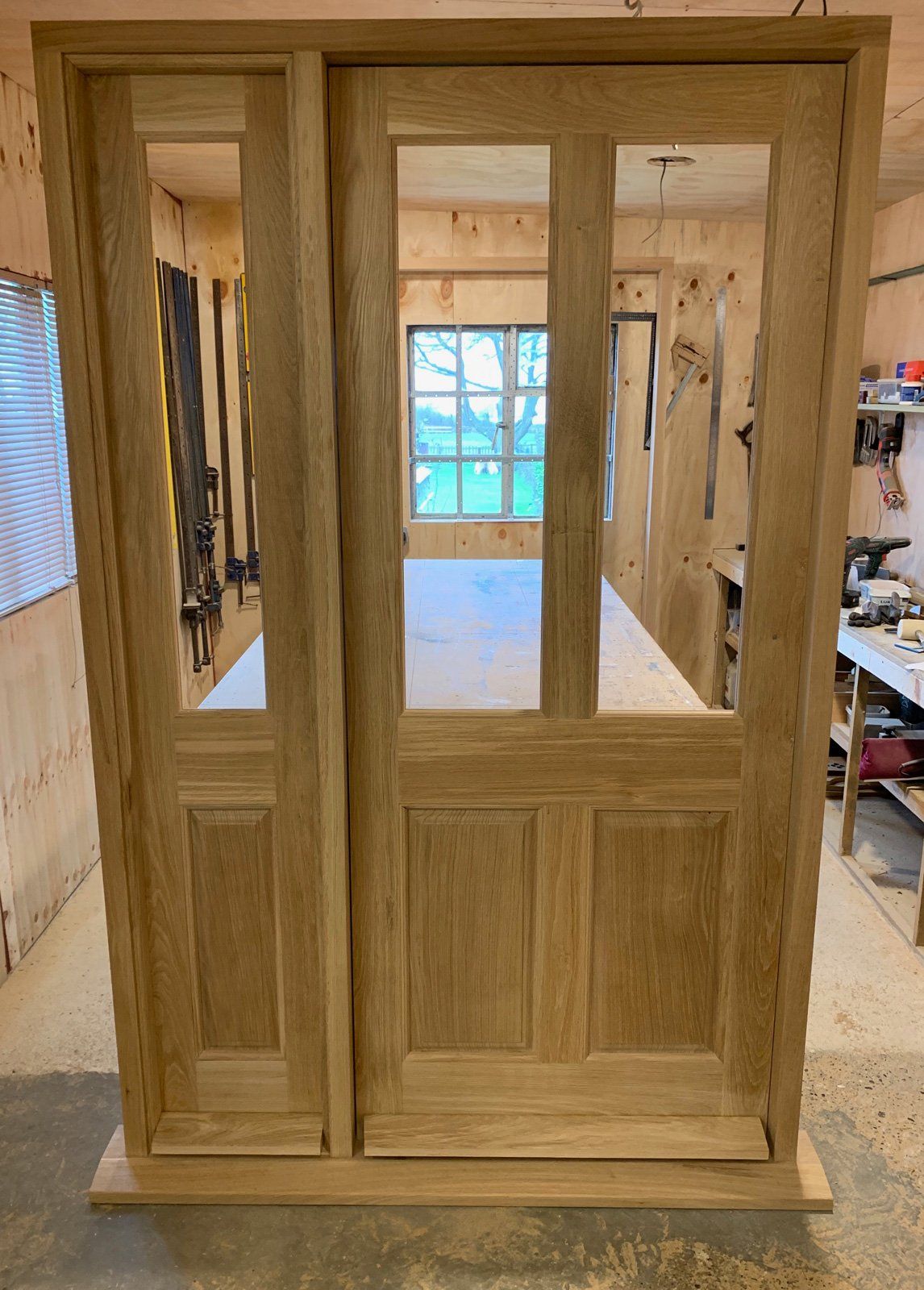 A wooden door is sitting on top of a wooden table in a room.