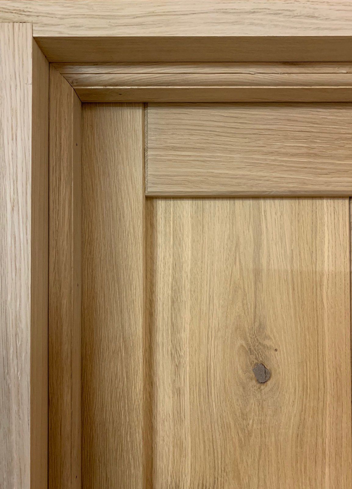 A close up of a wooden door with a molding on it.