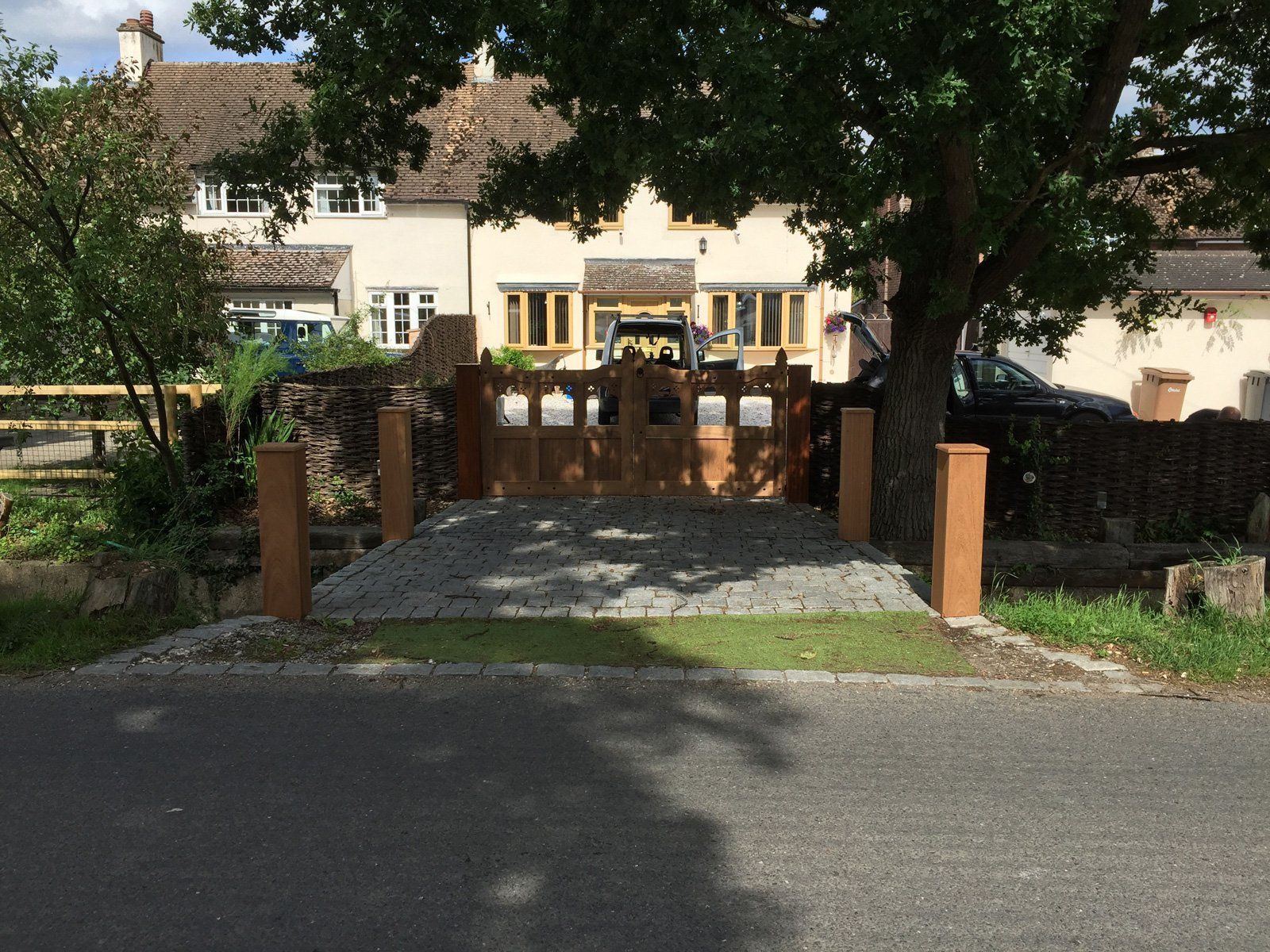 A large white house with a wooden gate in front of it