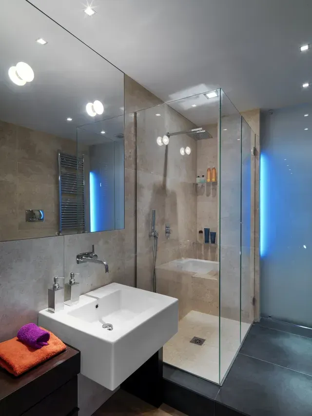 A bathroom with a sink and a walk in shower
